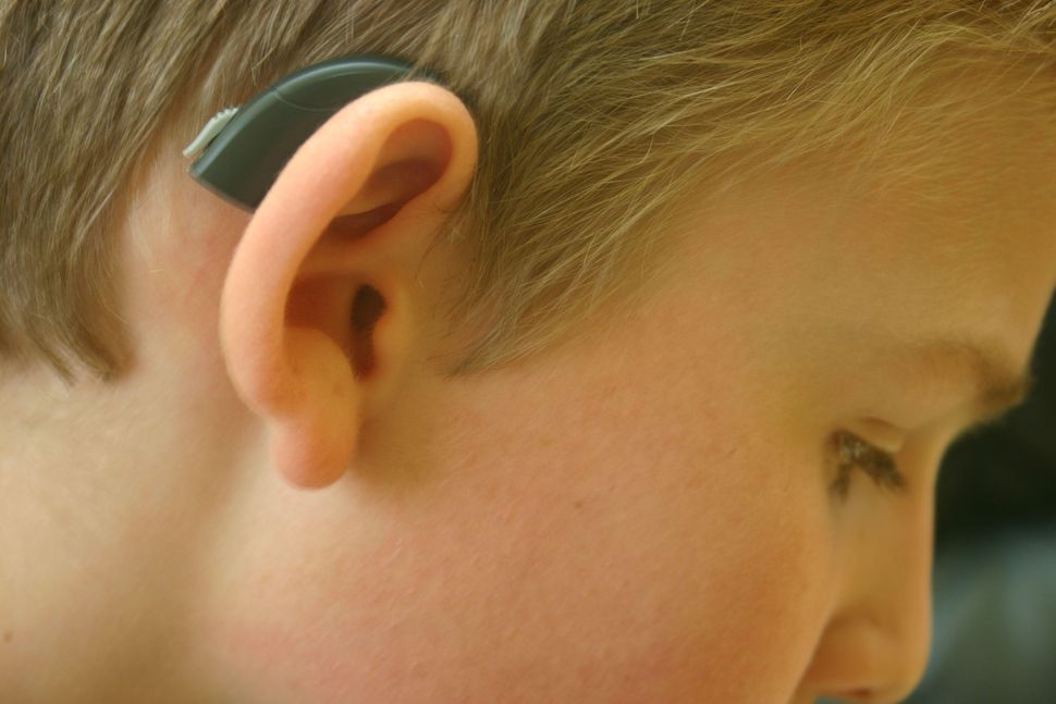 A boy with a hearing aid